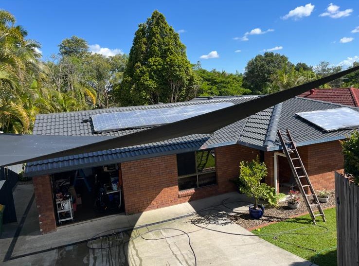 A house featuring solar panels installed on its roof, showcasing renewable energy use.