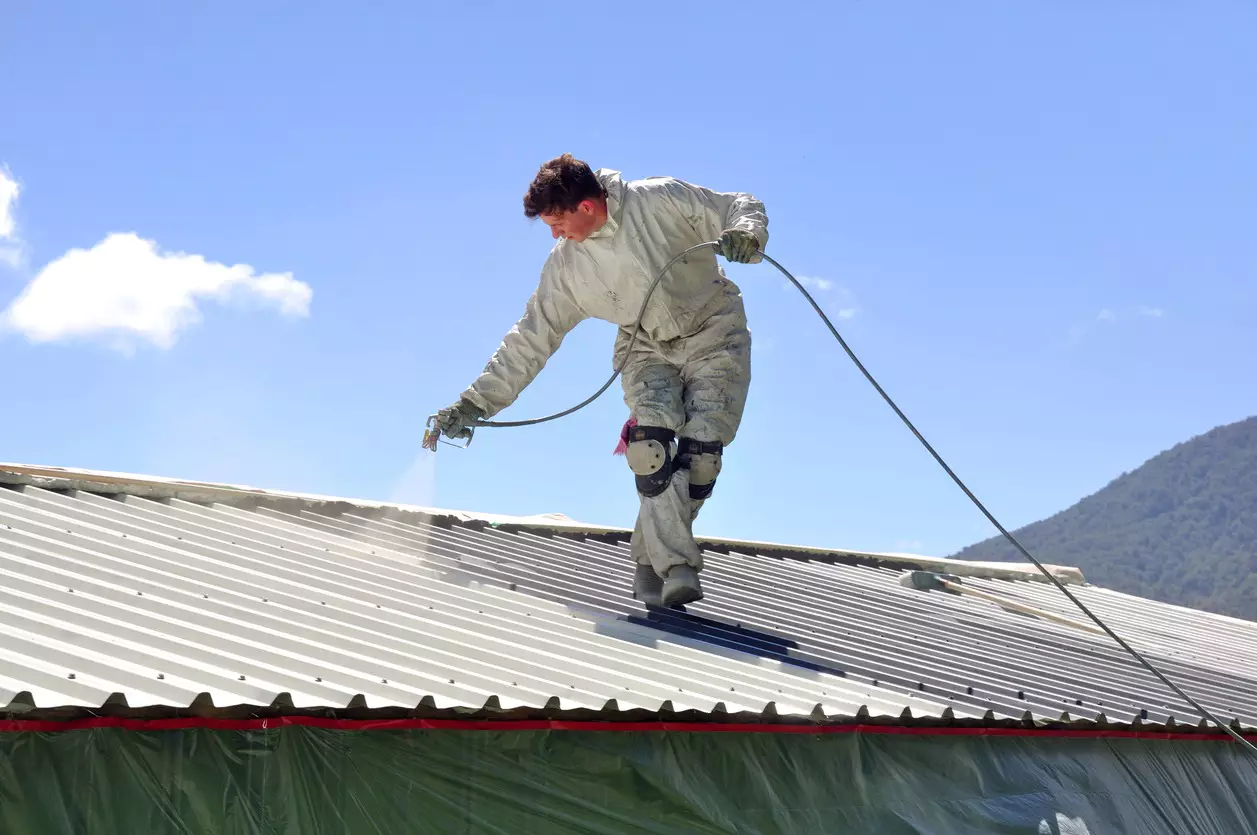 A-man-Sparying-Roof-Sealing and cleaning